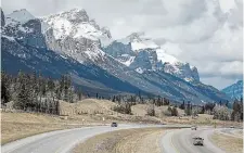  ?? JEFF MCINTOSH THE CANADIAN PRESS ?? Traffic travels along the Trans Canada Highway past Mount Rundle of the Rocky Mountains near Canmore, Alta. Snow in these regions typically wouldn’t start melting until late May or June, but has begun showing signs of snow thawing as early as March.