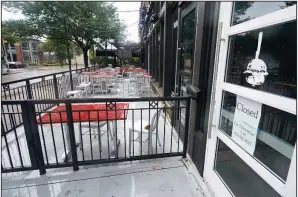  ?? (AP) ?? The patio of a closed burger restaurant sits empty Sept. 2 in Dallas. The number of people seeking unemployme­nt aid ticked up last week.