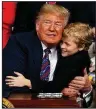  ?? AP/EVAN VUCCI ?? President Donald Trump hugs 8-year-old muscular dystrophy patient Jordan McLinn after signing the legislatio­n Wednesday at the White House.