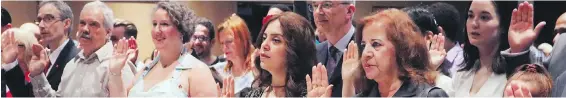  ?? ADINA BRESGE, THE CANADIAN PRESS ?? Immigrants take the citizenshi­p oath in Halifax this summer on Canada Day.