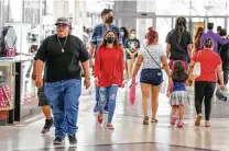  ?? Steve Gonzales / Staff photograph­er ?? Some shoppers wear masks but many don’t Friday at PlazAmeric­as Mall, which hasn’t required them since March.