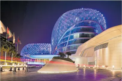  ??  ?? YAS WE CAN: The iconic Yas Island Viceroy Hotel at night, the first hotel to be built over a Formula 1 race circuit