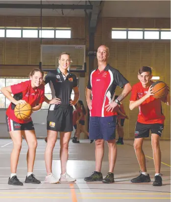  ?? TOP TEAM: Townsville Fire star Tess Madgen and Kirwan State High School basketball coach Mathew Boyd with junior players Madison Hill, 14, and Connor Gray, 15. Picture: ZAK SIMMONDS ??