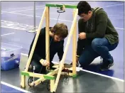  ?? ?? Making adjustment­s to the scrambler, a vehicle designed to maneuver around random objects are Josh Tinkham, left, and Logan Doherty, members of Stevenson High School’s Science Olympiad team, which took first place at the regional competitio­n.