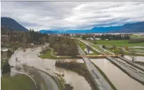  ?? DARRYL DYCK/THE CANADIAN PRESS ?? A Tiger Dam is placed across all lanes of the closed Trans-canada Highway in Abbotsford, B.C., on Dec. 1.