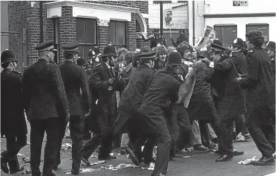  ?? Picture: Press Associatio­n. ?? Police restrain pickets at the Grunwick factory in London in June 1977.