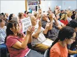  ?? Gina Ferazzi Los Angeles Times ?? PARENTS APPLAUD after the Murrieta Valley school board in August approves its notificati­on policy on students who change their gender identity.