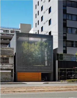  ??  ?? Above: Optical Glass House in Hiroshima, built in 2012 by Hiroshi Nakamura & NAP, hides from a busy road behind a soundproof glass facade encasing an ornamental garden.
Facing page: Cliff House, a cantilever­ed concrete tube that juts out over a river in Nara prefecture, was designed in 2015 by Planet Creations as a weekend fishing retreat.