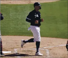  ?? ROSS D. FRANKLIN — THE ASSOCIATED PRESS ?? White Sox slugger Eloy Jimenez, right, will miss a good chunk of the season as he needs surgery to repair a torn pectoral tendon.