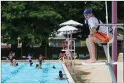  ?? MICHAEL CONROY — THE ASSOCIATED PRESS ?? Lifeguard Elizabeth Conley keeps an eye on the swimmers at the Douglass Park pool in Indianapol­is, Friday.