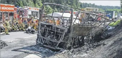  ?? aP PHoTo ?? The wreckage of a burnt-out bus remains at the scene of a fatal accident near Muenchberg, Germany, Monday.