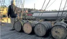  ?? IRONWORKS DISTILLERY/ THE CANADIAN PRESS ?? Barrels of rum from Ironworks Distillery rest before being loaded on a tall ship in this undated handout photo. Over the next 15 months, four barrels of rum from Ironworks Distillery in Lunenburg, N. S., will travel in the cargo hold of the three-...