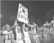  ?? LORRIE CECIL/THISWEEK ?? Central Crossing's Elijah Fleshman (12), Nate Smith (55), Alec Boyd (4) and Jae'v'on Pass celebrate with their teammates after the Comets defeated host Grove City 19-14 on Friday.