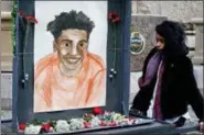  ?? KEITH SRAKOCIC - THE ASSOCIATED PRESS ?? A woman who did not want to be identified holds a memorial display with a drawing of Antwon Rose II in front of the court house on the first day of the trial for Michael Rosfeld, a former police officer in East Pittsburgh, Pa.