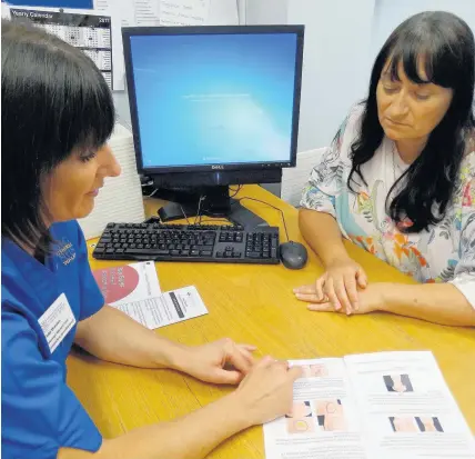  ??  ?? Julia Warwick, who works at Swansea’s Morriston Hospital, has become the first breast reconstruc­tion nurse specialist in Wales. She’s pictured with patient Catherine Kirkup