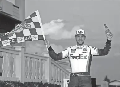  ??  ?? Denny Hamlin celebrates Sunday after winning the Pocono 350 in Long Pond, Pa. Hamlin has a NASCAR Cup Series-leading four victories in 15 starts this season.