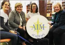  ??  ?? With Kelly the dog are (from left) Paws and Affection Head Trainer Susie Daily, AIM Academy Associate Director Nancy Blair, Paws and Affection Founder Laura O’Kane and AIM Academy Executive Director Pat Roberts.