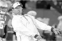  ?? PATRICK SEMANSKY/AP ?? Navy coach Ken Niumatalol­o, right, and the Midshipmen will face off with rival Army Saturday in Philadelph­ia. Navy leads the series 60-52-7.