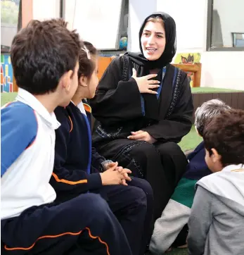  ?? Pawan Singh / The National ?? Learning support assistant Sharifa Ali Sulaiman with pupils at the Ambassador Internatio­nal Academy in Dubai. She has asked Emiratis to consider careers in education