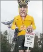  ?? JAMES BOARDMAN/ AFP/GETTY IMAGES ?? British artist Frank Shepherd puts the finishing touches to a Lance Armstrong effigy.