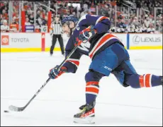  ?? Nick Wass The Associated Press ?? Capitals left wing Alex Ovechkin takes a shot during the first period of Washington’s 4-3 victory over Florida at Capital One Arena. Ovechkin scored his first hat trick of the season and 28th of his career.