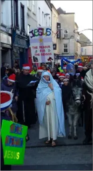  ??  ?? ‘Mary’ and ‘Joseph’ on Wexford’s Main Street last year. Maura O’Donoghue will have no need for the pillow prop this Christmas Eve.