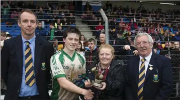 ??  ?? Martin Fitzgerald, Mrs Price and Martin Coleman prsent the Man of the Match award to Baltinglas­s’s Johnny Keogh.