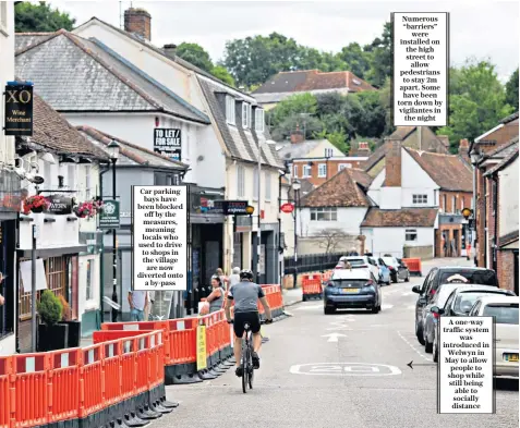  ??  ?? Car parking bays have been blocked off by the measures, meaning locals who used to drive to shops in the village are now diverted onto a by-pass
Numerous “barriers” were installed on the high street to allow pedestrian­s to stay 2m apart. Some have been torn down by vigilantes in the night
A one-way traffic system was introduced in Welwyn in May to allow people to shop while still being able to socially distance