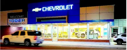  ?? AP ?? A vehicle passes a Chevrolet dealership in Fort Lupton, Colorado. Many car shoppers neglect a key factor that can help save money: getting the best value for their trade-in vehicle.