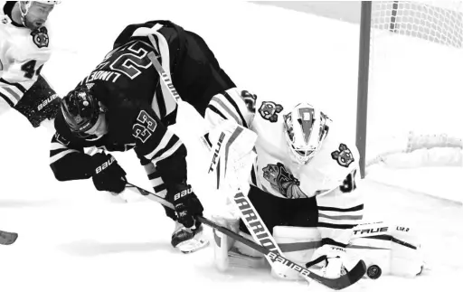  ?? MATT STRASEN/AP ?? Hawks goaltender Kevin Lankinen blocks a shot by Stars defenseman Esa Lindell in the first period Thursday in Dallas. Lankinen had 28 saves.