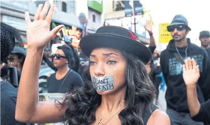  ?? DAVID MCNEW/GETTY IMAGES FILE PHOTO ?? People march in Los Angeles in protest of a court decision not to indict a police officer involved in the death of Eric Garner in 2014.