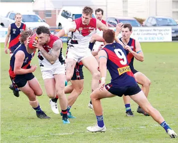  ?? ?? Warragul’s Brayden Fowler bursts through a pack while teammate Mitchell Smart lays a shepherd.