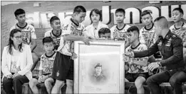  ?? LINH PHAM/GETTY ?? Boys from the Thai soccer team and their coach pay tribute during their first news conference to ex-SEAL diver Saman Gunan, who died during the rescue operation.