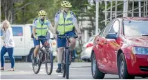  ?? PHOTO: STUFF ?? Constable Ben Hopkins and Sergeant Hamish Knight are part of Wellington’s new Police on Bikes patrol, that will spot texters in cars and other misdemeano­urs.