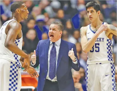  ?? THE ASSOCIATED PRESS ?? Kentucky coach John Calipari talks to Edrice Adebayo, left, and Derek Willis during the Wildcats’ win against Alabama in the SEC tournament this month. Joining the Wildcats in the NCAA tourney’s Sweet 16 this week are Florida and South Carolina.