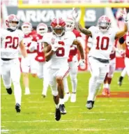  ?? AP PHOTO/MICHAEL WOODS ?? Alabama senior star DeVonta Smith (6) returns a punt for an 84-yard touchdown during the first quarter of Saturday’s game at Arkansas. Smith’s score sparked the start of a scoring onslaught for the Crimson Tide, who won 52-3.