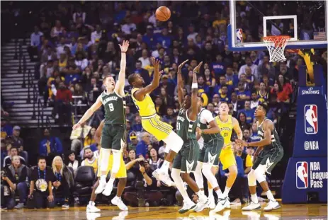  ?? (AFP) ?? Kevin Durant (second left) of the Golden State Warriors loses the ball while guarded by Donte DiVincenzo (left) and Tony Snell of the Milwaukee Bucks.