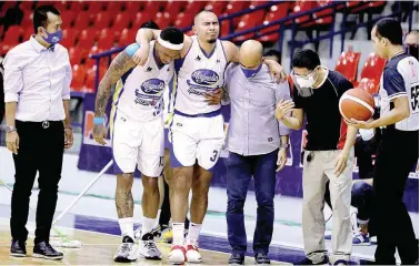  ?? (PBA Images) ?? Paul Lee grimaces in pain after hurting his leg during Magnolia's PBA Philippine Cup game against Terrafirma Friday, July 30 at the Ynares Sports Arena in Pasig City. Despite losing Lee, Magnolia went on to win, 105-83.