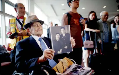  ?? Reuters ?? a man who has been selected as a participan­t for a reunion holds an old picture at a hotel in Sokcho, South Korea, on Sunday. —