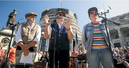  ?? ROBERT KITCHIN/STUFF ?? The Topp Twins, MCs for the event alongside Wellington Paranormal’s Karen O’Leary, say they believe RNZ Concert should stay forever; below, performanc­es took place at Parliament by supporters yesterday.