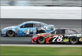  ?? AP/MARY SCHWALM ?? Kevin Harvick (left) and Martin Truex Jr. race through Turn 1 on Sunday during the NASCAR Monster Energy Cup Series race at New Hampshire Motor Speedway in Loudon, N.H. Harvick won the race, while Truex finished fourth.
