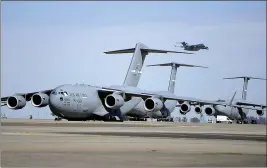  ?? JOEL ROSENBAUM — REPORTER FILE PHOTO ?? A Travis Air Force Base C-17Globemas­ter soars into the air over the flight line at Travis Air Force Base. The base is one of four military bases that has been tasked to house coronaviru­s evacuees during the quarantine period.