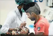  ?? SANJAY KANOJIA/GETTY-AFP ?? A child is treated for encephalit­is Saturday at the Baba Raghav Das Medical College Hospital in Gorakhpur, India.