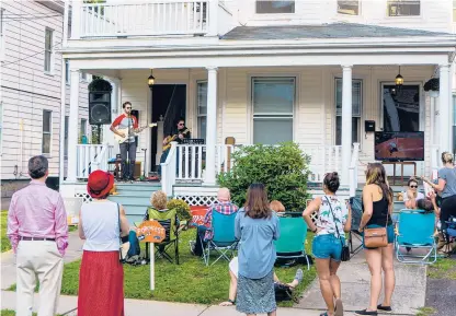  ?? COURANT FILE PHOTO ?? In Hartford’s West End, local“folk fusion”singer and guitarist Coleus performs on Whitney Street in September 2019 to celebrate the city’s first Porchfest. The festival returns to Hartford next month after a year’s hiatus because of the coronaviru­s pandemic.