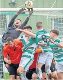  ?? ?? Rothes keeper Sean Mccarthy gets to grips with this pile-on