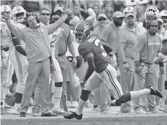  ?? THE ASSOCIATED PRESS PHOTOS ?? Tennessee coach Butch Jones reacts to a catch and run for a first down by Alabama wide receiver Calvin Ridley during the Crimson Tide’s 45-7 win over Tennessee on Saturday.