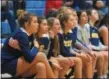  ?? AUSTIN HERTZOG - MNG ?? Suspended members of the Pope John Paul II girls basketball team sit on the bench during the team’s PAC semifinal last Saturday.