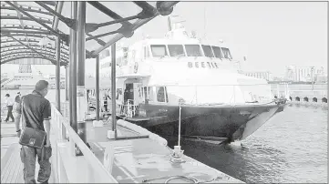  ??  ?? The Beetle, a hydrofoil, waits to depart from Hakata Port in Fukuoka, Japan, across the Tsushima Strait to Busan in South Korea. Both industrial harbours have long been involved in the exchange of goods and ideas among Japan, Korea and China.