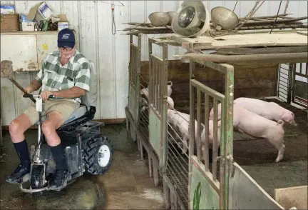  ?? ANDREW SOREGEL VIA AP ?? Mark Hosier, 58, rides a scooter as he checks on his pigs on his farm in Alexandria, Ind. Hosier was injured in 2006, when a 2000-pound bale of hay fell on him while he was working. Assistive technology, help from seasonal hires and family members, and a general improvemen­t in the health of U.S. seniors in recent decades have helped farmers remain productive and stay on the job well into their 60s, 70s and beyond.