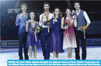  ?? — AFP ?? BEIJING: First place winner Gabriella Papadakis and Guillaume Cizeron of France (Center), second place winner Madison Chock and Evan Bates of the US (L) and third place winner Ekaterina Bobrova and Dmitri Soloviev of Russia (R) show their medals during...